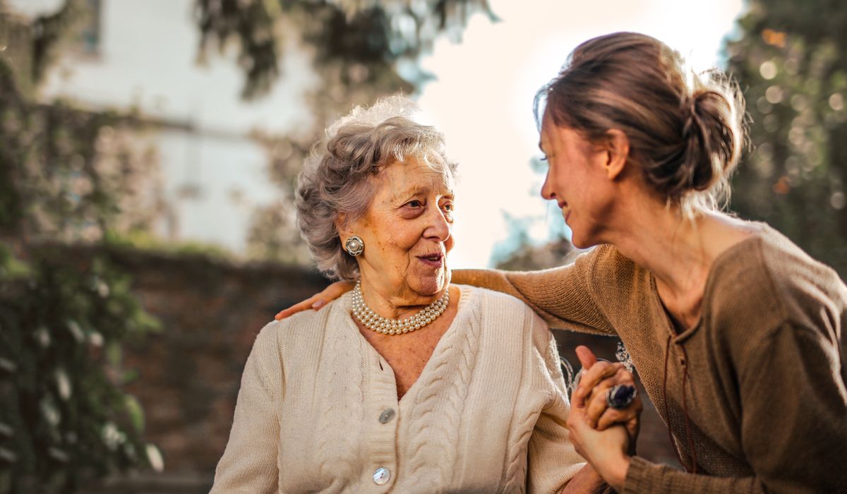 Adult child welcoming an elderly parent